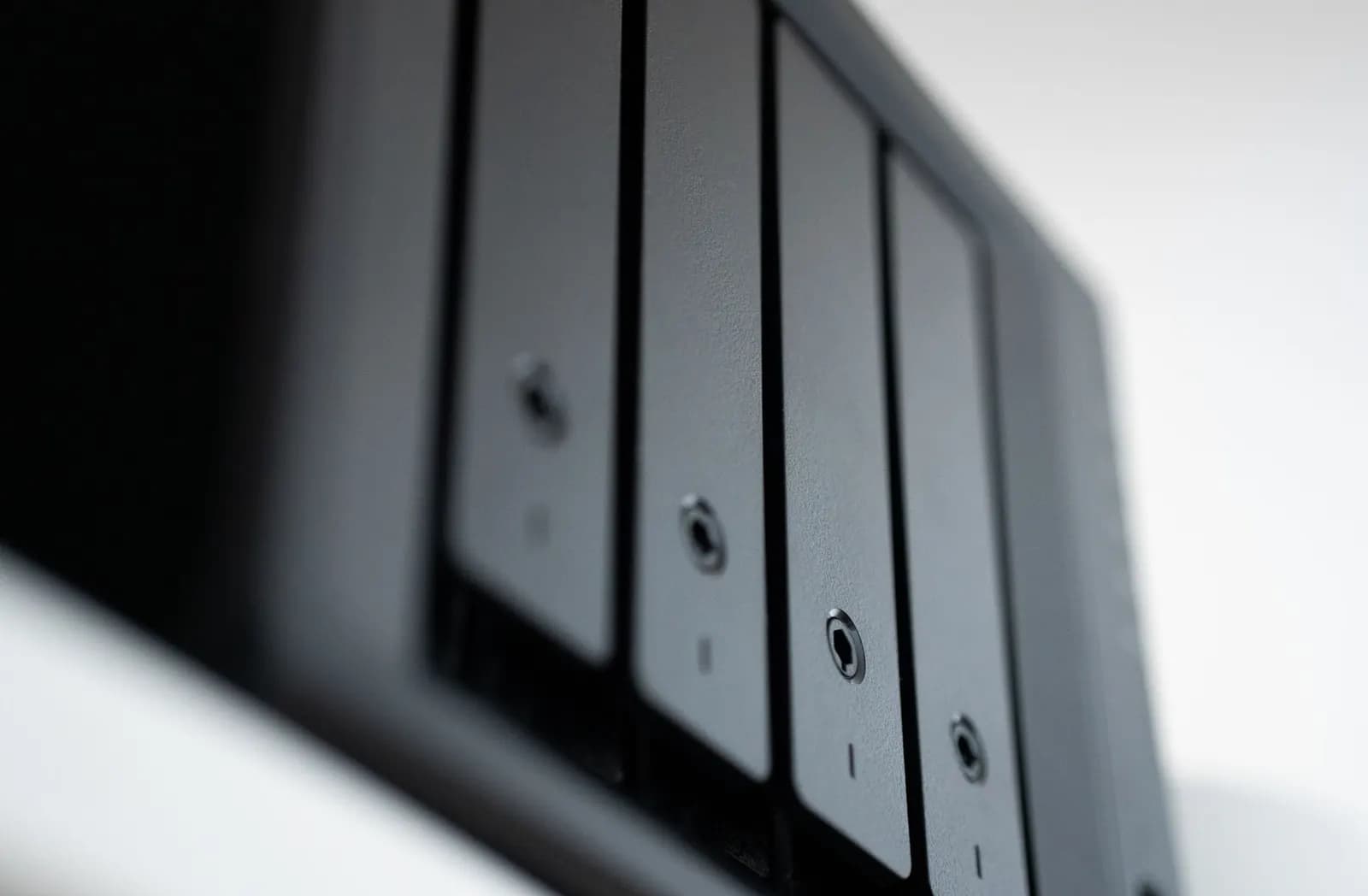 Close-up of the drive bays on a small black network storage device